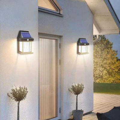 Solar-powered outdoor lights on a house exterior with plants and a door.