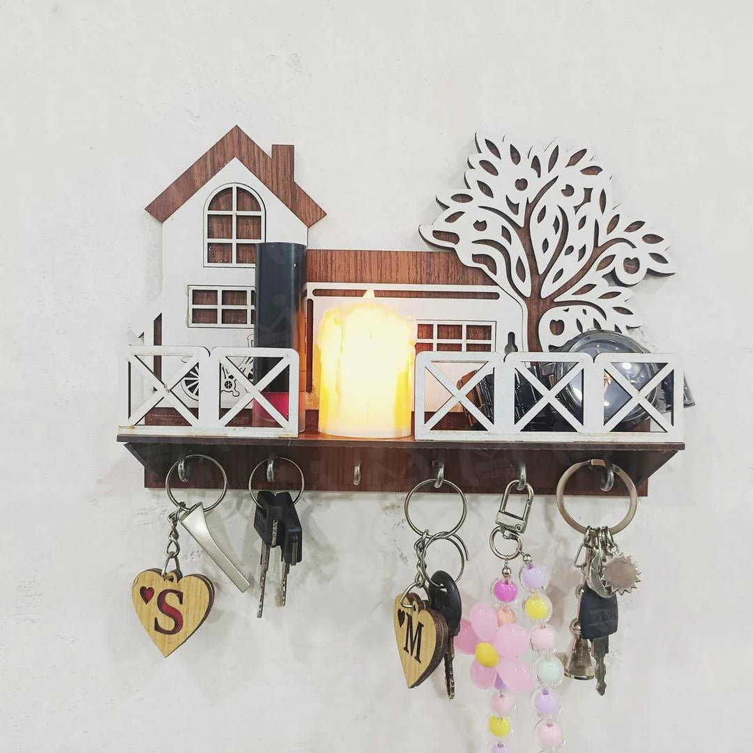 Wall-mounted key holder with decorative items on a white wall
