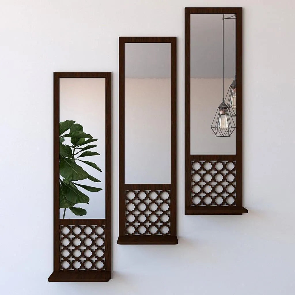 Three tall wall mirrors with decorative wooden frames on a white wall.