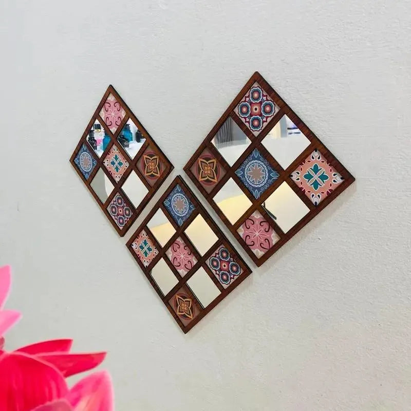 Decorative wall mirrors with geometric patterns on a plain wall.