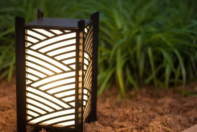 Decorative outdoor lantern with wavy pattern on a natural background