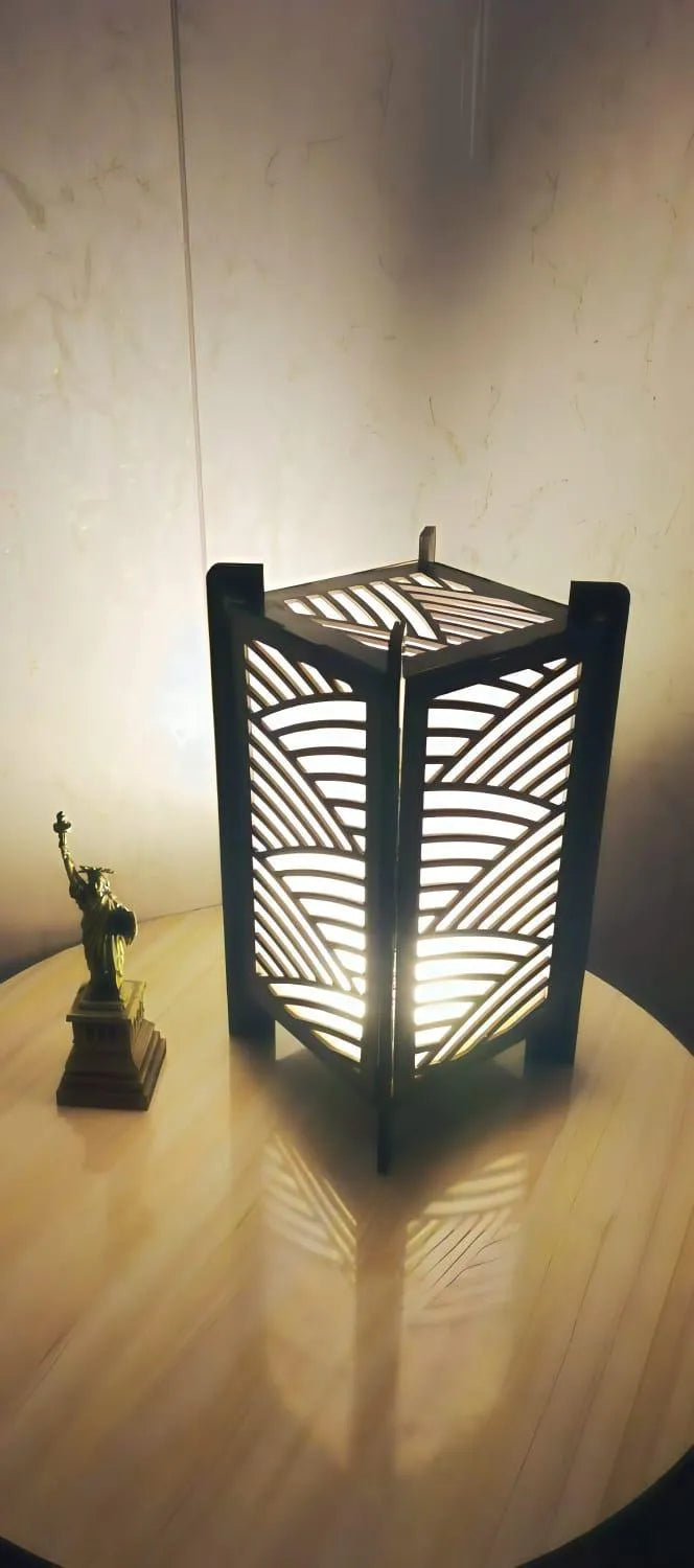 Decorative lamp with intricate design on a wooden surface
