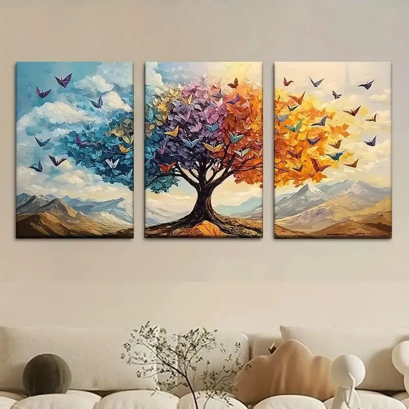Three-panel wall art of a tree with colorful butterflies and mountains in a living room setting.