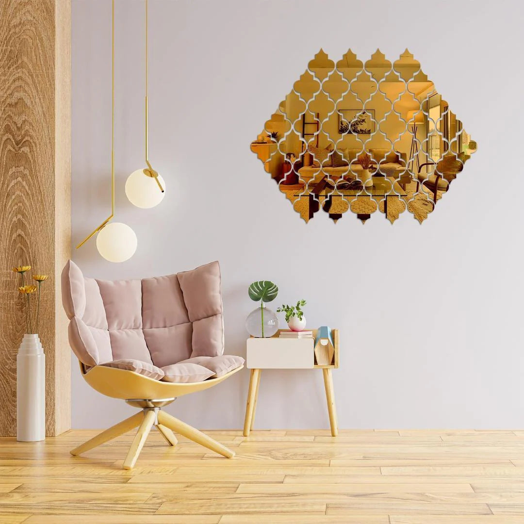 Decorative gold mirror wall art in a modern living room with a chair and side table.