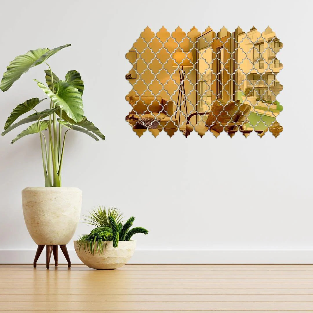 Decorative wall sticker with geometric design on a white wall, accompanied by potted plants.