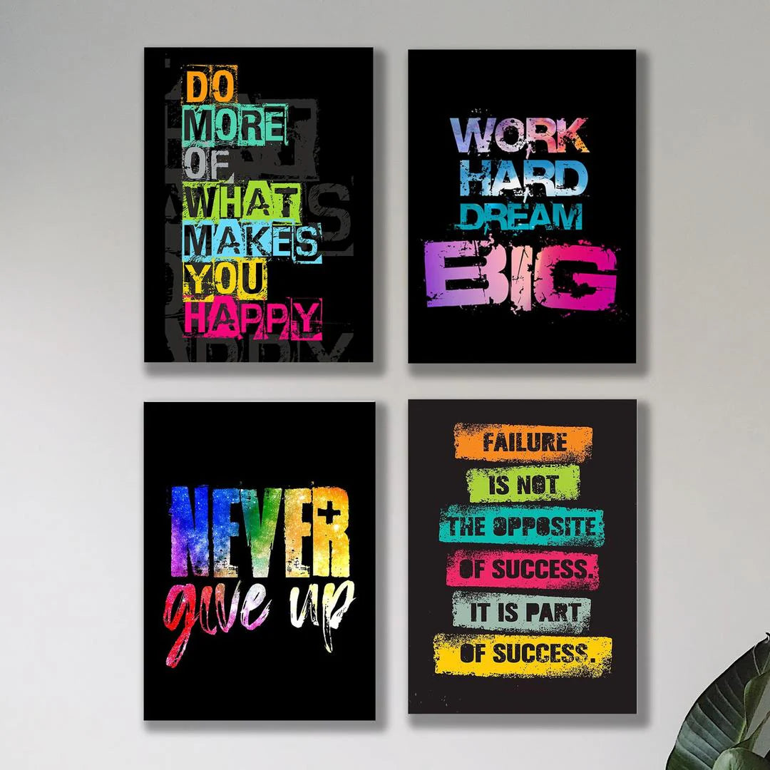 Four motivational posters with colorful text on a wall.