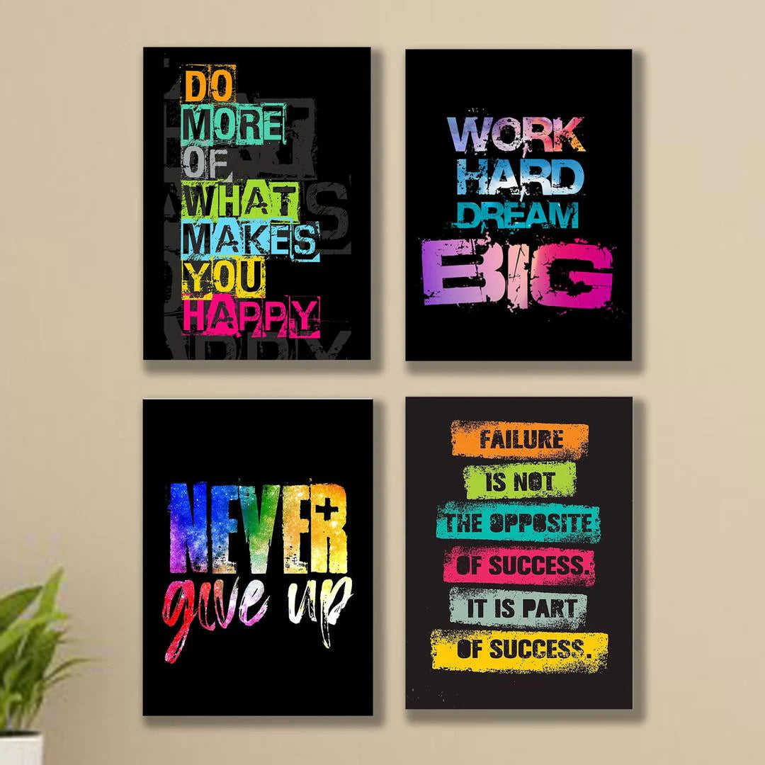 Four motivational posters with colorful text on a beige wall.