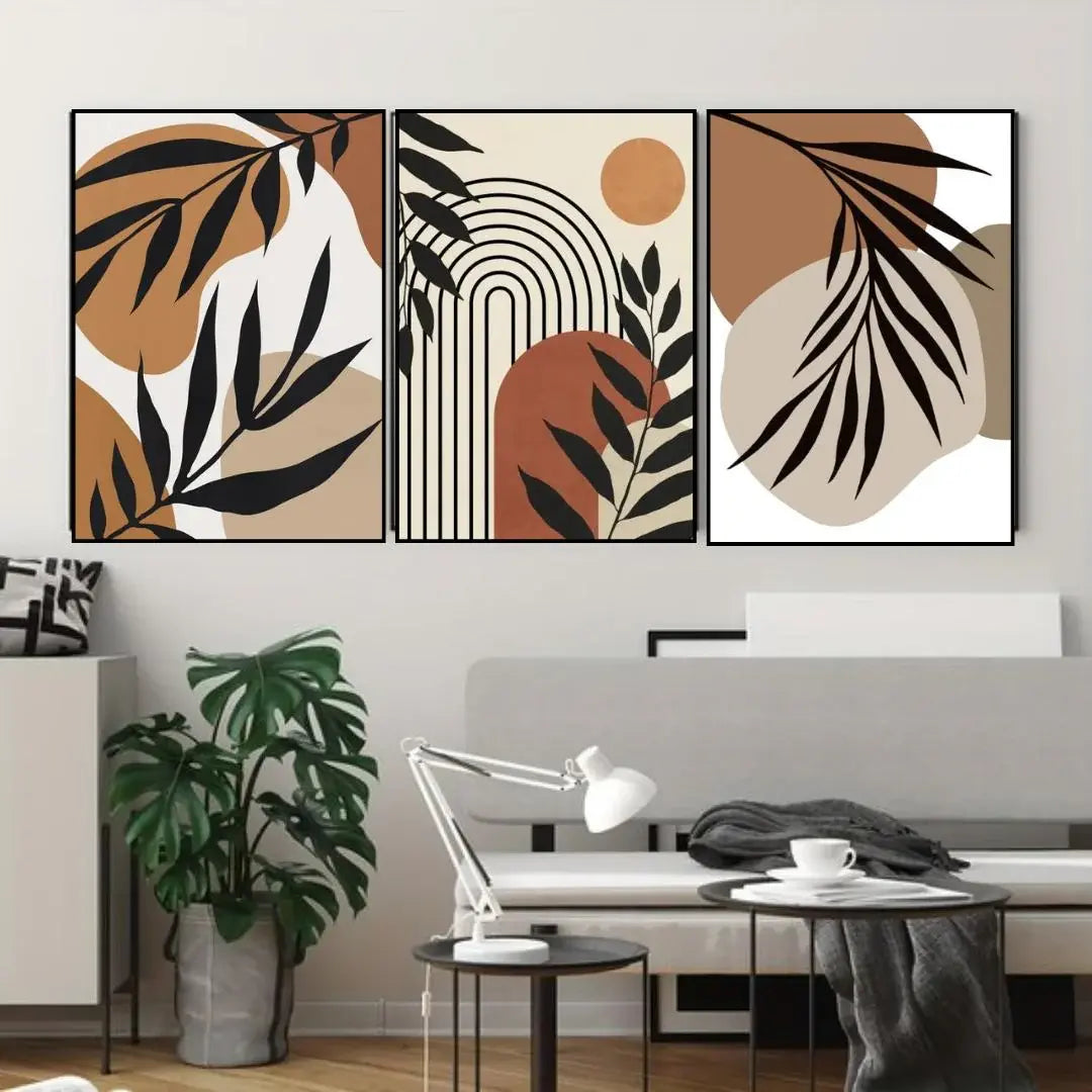 Three abstract wall art pieces with leaf and geometric designs in a modern living room.