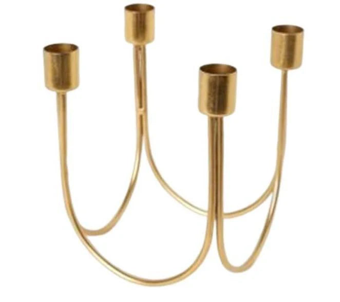 Gold metal candelabra with four candle holders on a white background