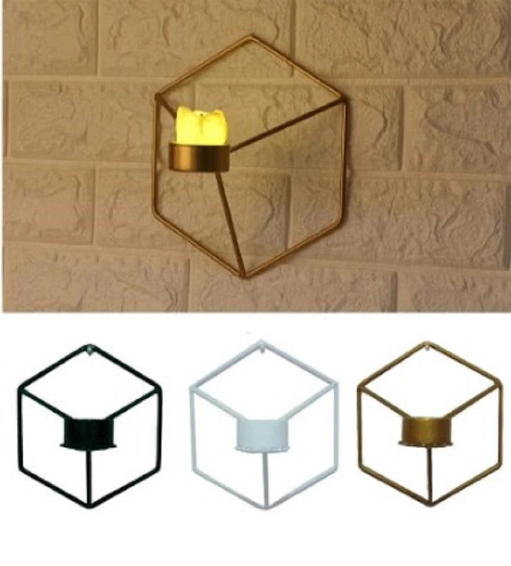 Hexagonal wall-mounted candle holder with a lit candle on a textured beige wall.