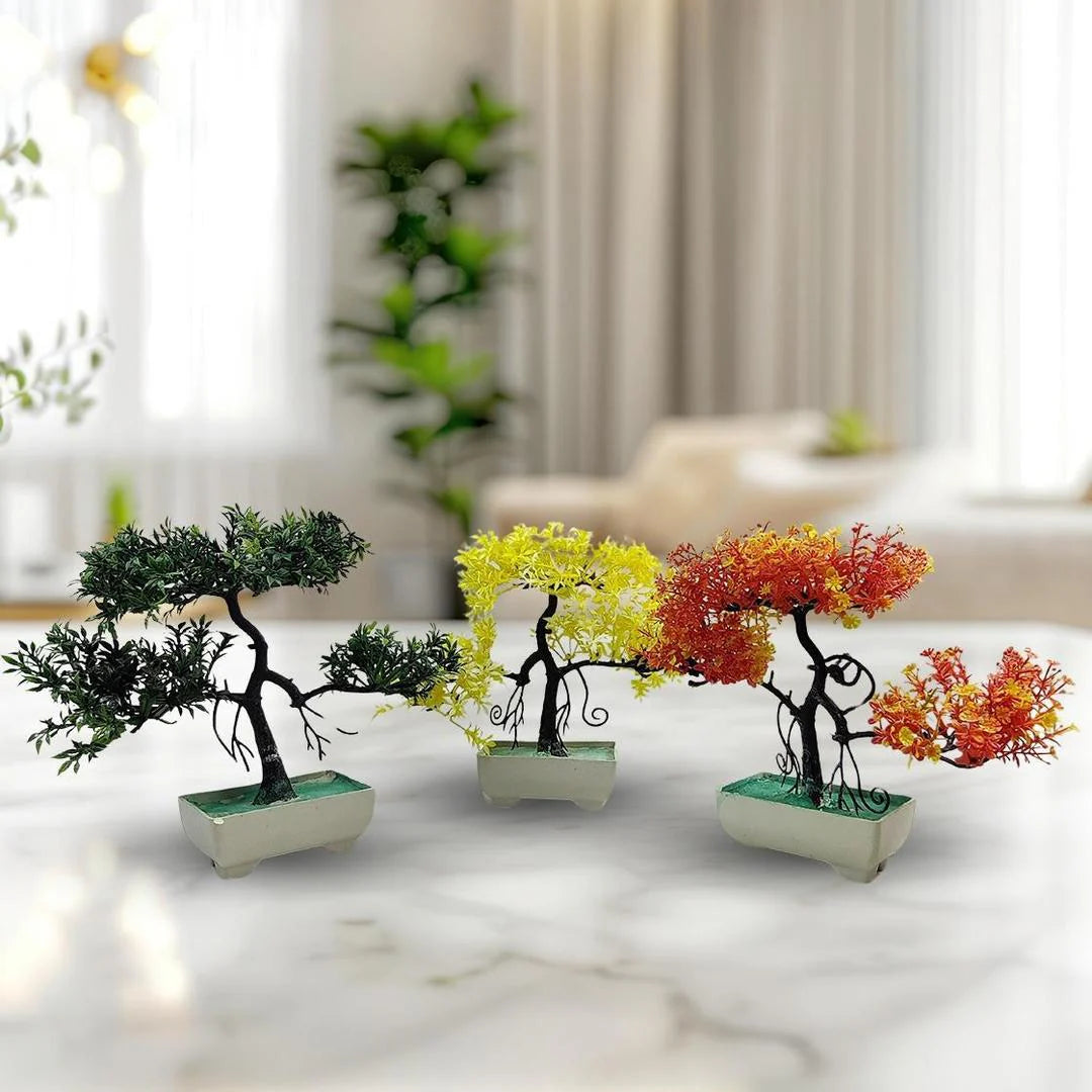 Set of four decorative bonsai trees in pots on a marble surface with a blurred indoor background.