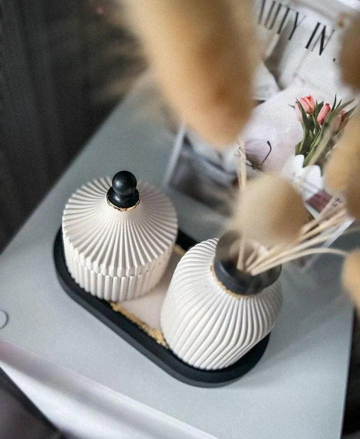 Two decorative vases on a surface with a blurred background