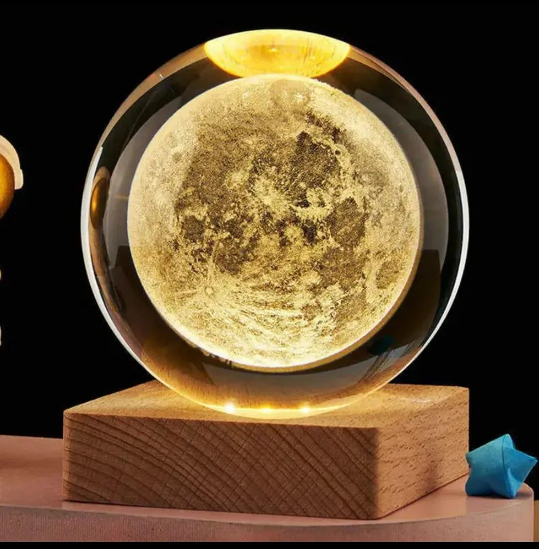 Glowing moon-shaped object on a wooden base with a black background