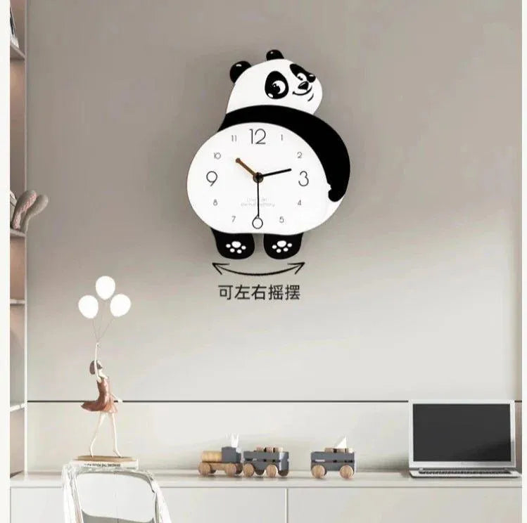 Panda-shaped wall clock on a wall above a desk with decorative items.