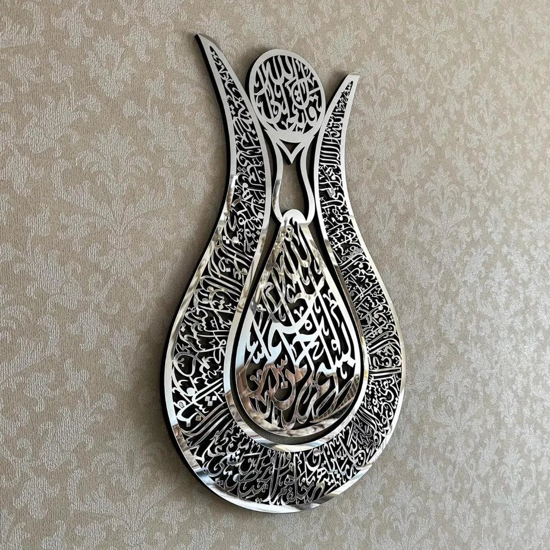 Decorative metal wall art with intricate designs on a beige background
