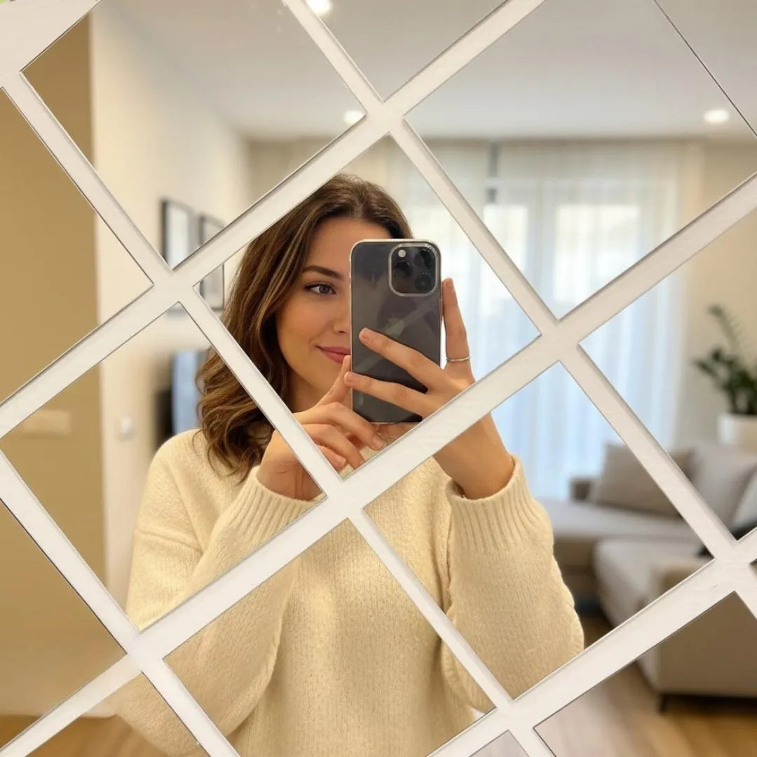 Woman taking a mirror selfie with a smartphone, framed by a decorative mirror with geometric pattern.