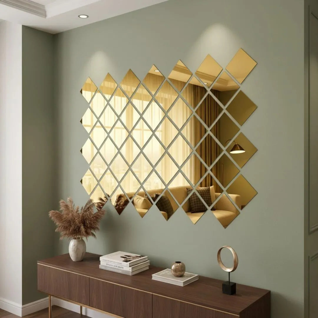 Decorative wall mirror with geometric design on a green wall above a wooden console table.