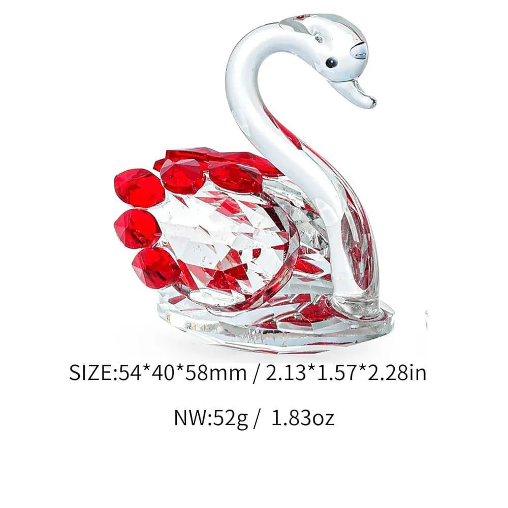 Crystal swan figurine with red berries on a white background
