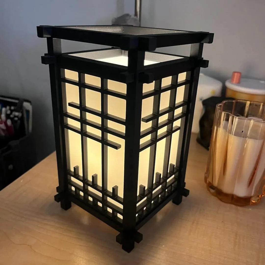 Black lantern with grid design on a wooden surface