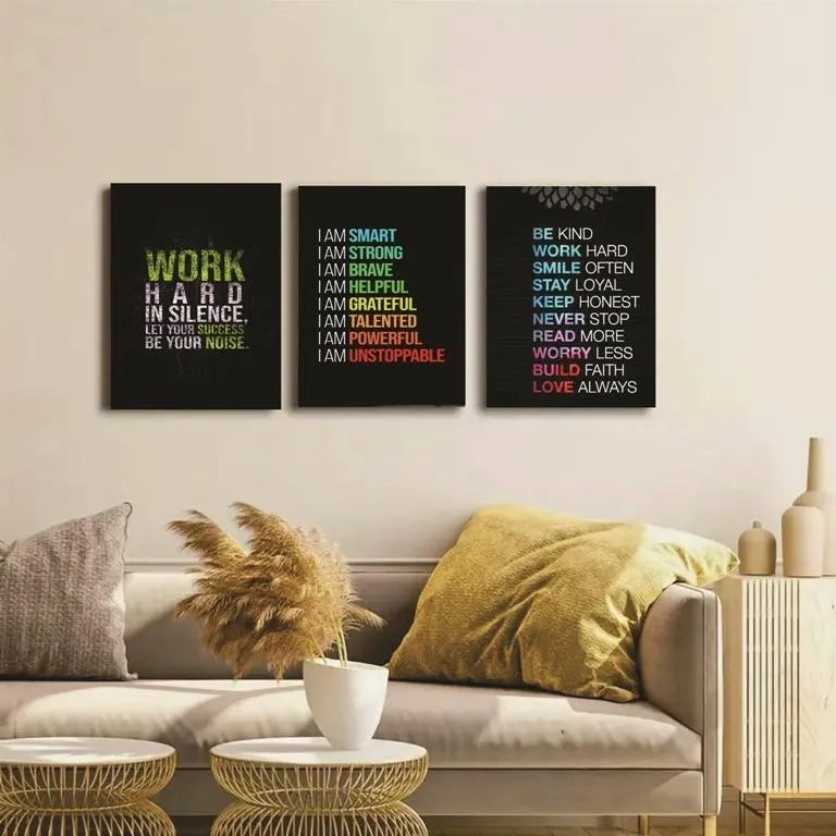 Three motivational posters on a wall above a sofa in a living room.