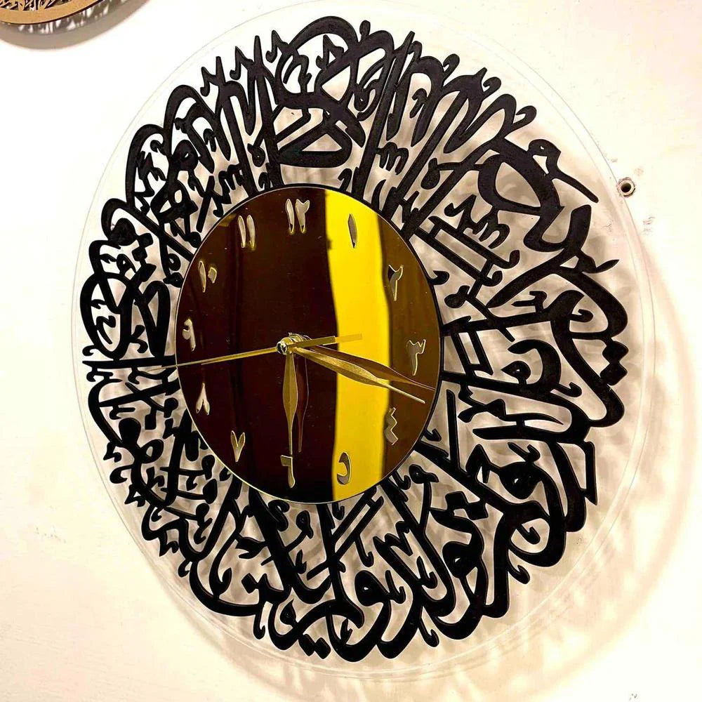 Decorative wall clock with black Arabic calligraphy design on a white background