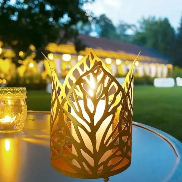 Decorative metal lantern with leaf pattern on a table outdoors