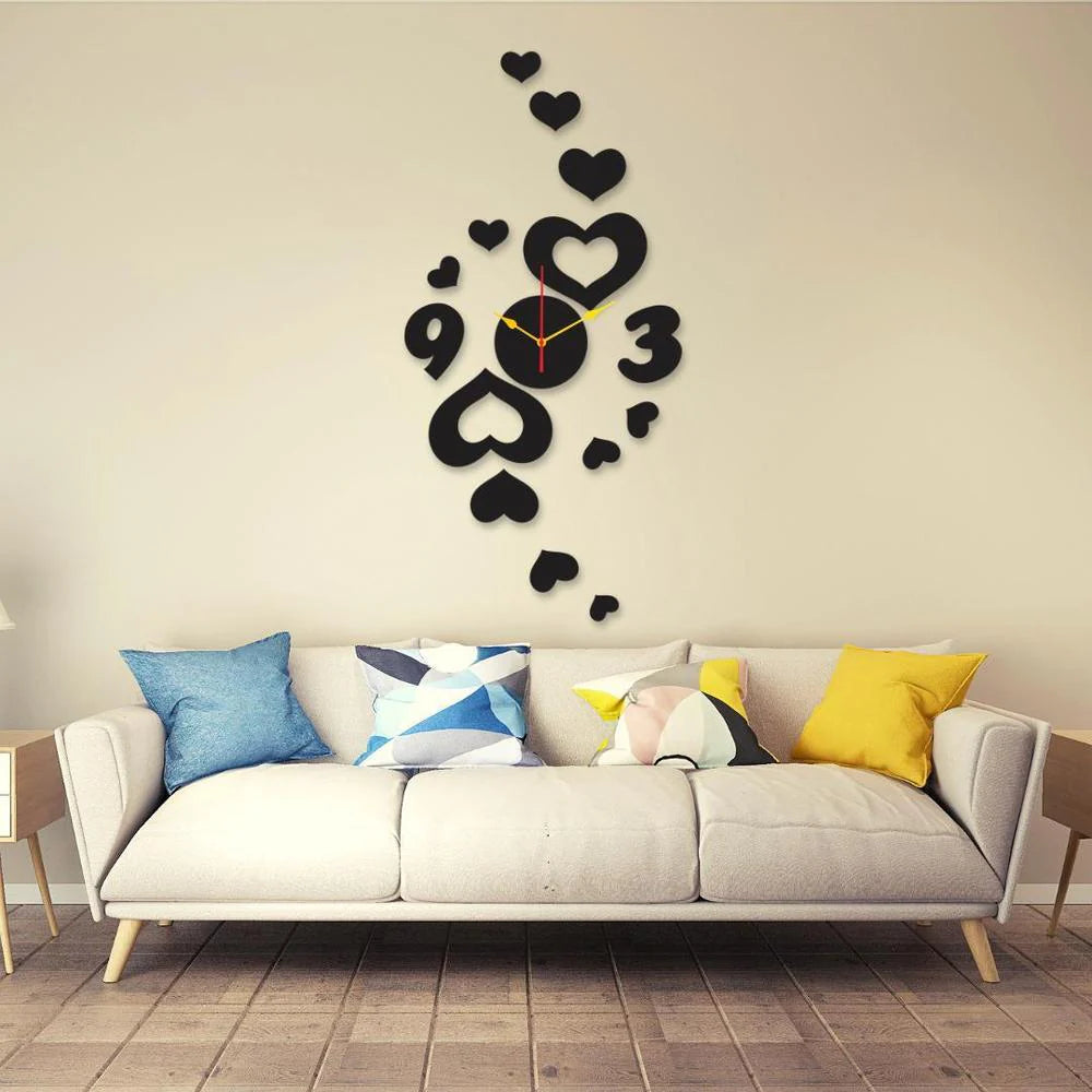 Black heart-shaped wall clock on a beige wall above a sofa with colorful cushions.