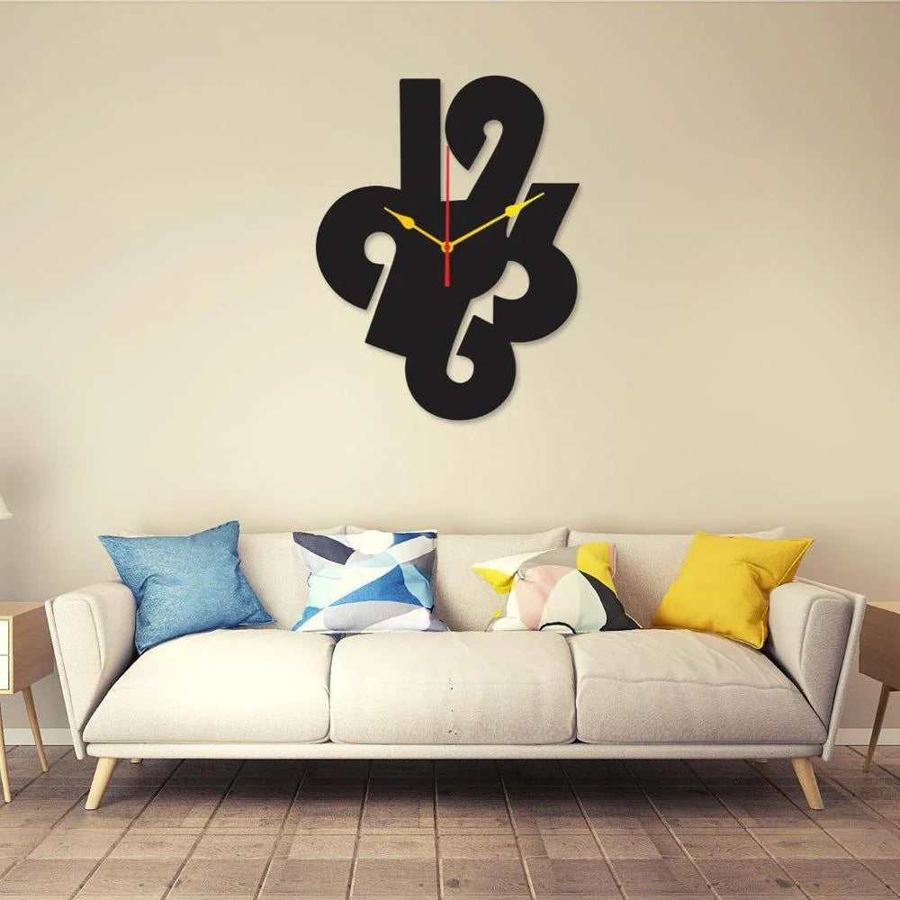 Modern wall clock with abstract design on a beige wall above a sofa with colorful cushions.