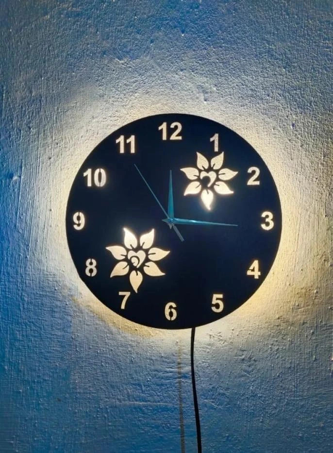 Decorative wall clock with floral designs on a textured wall